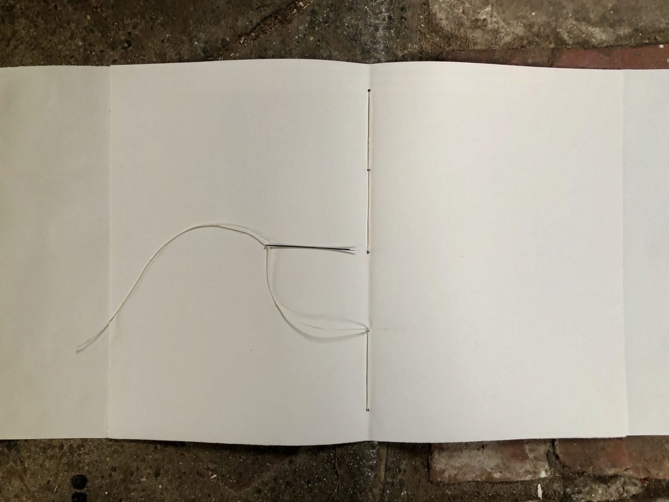 Make a journal - step twelve - back through the middle hole