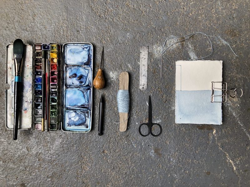 Make a stab binding with The Travelling Bookbinder - Pull thread tight